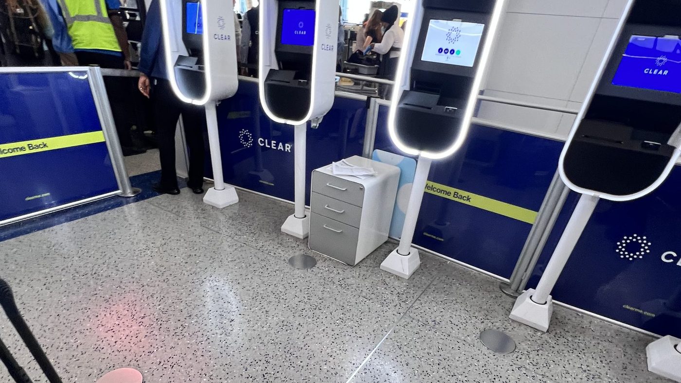 A bank of CLEAR biometric pods at Newark with travellers waiting beside them, on the day Rocky first tried the service in September 2022